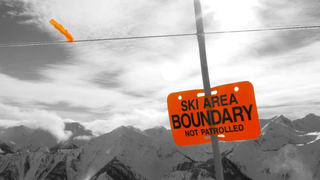 Ski Area Boundary sign. Rocky Mountains, BC, Canada. Black, white and orange.