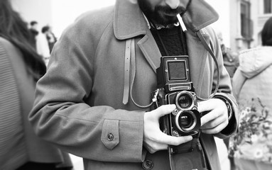 Close-up of Hipster man with the vintage camera. Photographer with a famous retro camera. Bologna,...