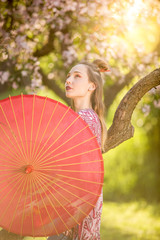 Beautiful woman japanese in park wearing kimano and holding umbrella
