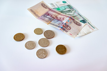 Russian rubles, coins and paper money on yhe white table