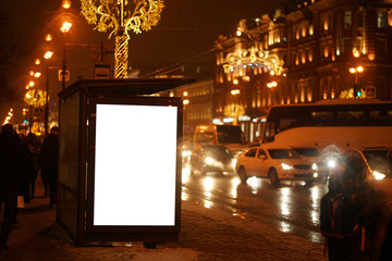 city outdoor billboard mockups Glows in the darkness of the night city Christmas decorations on the...