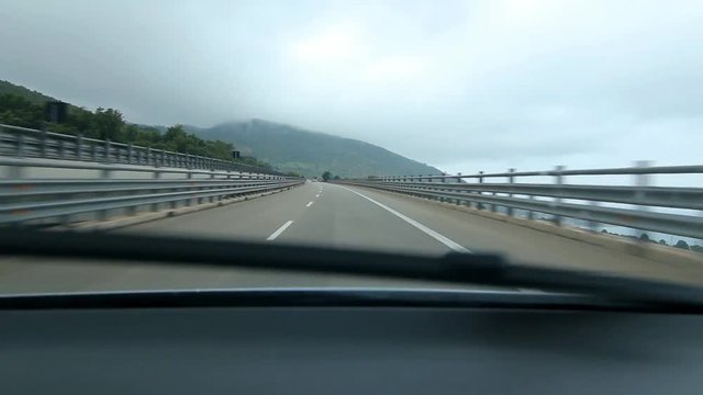 Driving on corner on elevated road on the E90, between Palermo and Messina in Sicily, Italy.