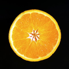 Fresh orange half isolated on black background