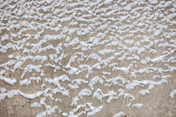 Texture background. Grey concrete wall with snow