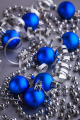 Christmas composition of Christmas tree toys on a blurred silver background