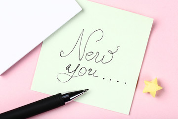 New you on paper with pen and yellow star
