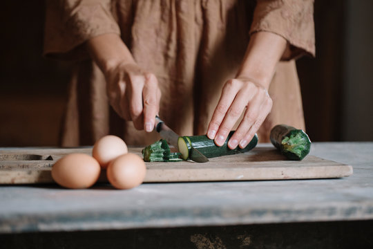 Woman slising small zucchini