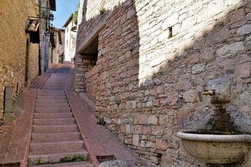 A medieval Street in the city Assisi , Italy.