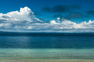 Blue sea and cloudy blue sky