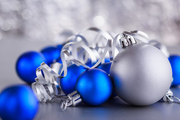 Christmas composition of Christmas tree toys on a blurred silver background