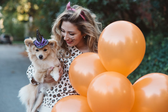 A teenage girl and her dog dressed up for halloween