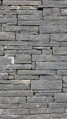 Vertical texture of grey slate wall tiles