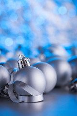 Christmas composition of Christmas tree toys on a blurred silver background