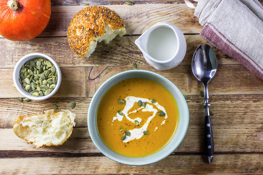 Roasted pumpkin and carrot soup with cream and pumpkin seeds