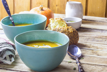 Roasted pumpkin and carrot soup with cream and pumpkin seeds