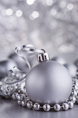 Christmas composition of Christmas tree toys on a blurred silver background