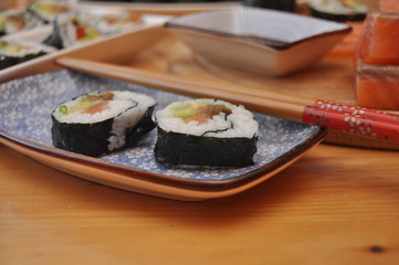 Fototapeta na wymiar Sushi. Delicious meal with fish, rice and supplements, prepared at home.