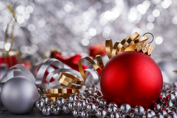 Christmas composition of Christmas tree toys on a blurred silver background