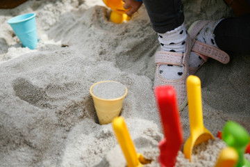 Little Girl Sitting in Sandpit