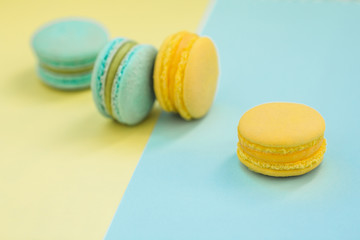 Macarons cake, top view flat lay, handmade pattern on yellow and blue background. Concepts about decoration, food background