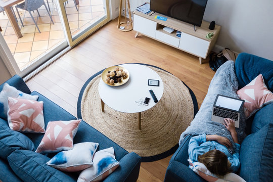 overhead view of teenager on sofa