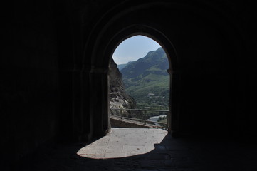 Fototapeta premium Old rock town in Vardzia, Georgia. The niches of the church and living quarters carved in a rock wall.