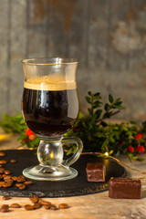 coffee in a transparent mug (with milk and spices). Top view. copy space