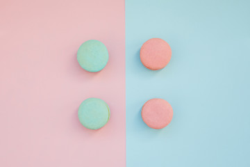 Pattern Of Multi-Colored Macaroons On A Blue and pink Background.top view. Flay lay selection of macarons