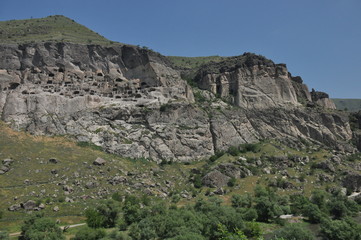 Old rock town in Vardzia, Georgia. The niches of the church and living quarters carved in a rock wall.