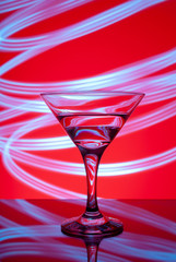 alcoholic glass in the club entourage, copy space, red background