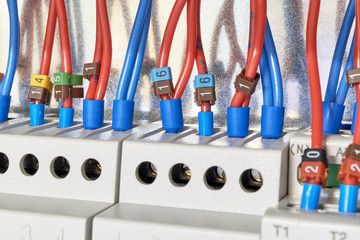 The electrical wires are connected to the intermediate relays and control devices. The cables are marked with numbers. Modern technologies in electrical and technical production.