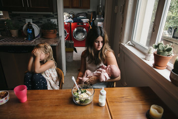 Real family dinner with stressed out mom, busy kids and all the chaos