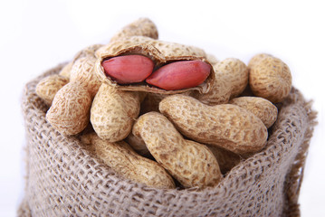Peanuts in a peel in a bag on a white background.