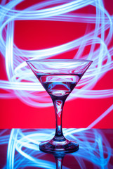alcoholic glass in the club entourage, copy space, red background