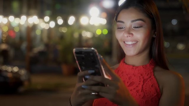 Woman Texting With Her Smartphone in The City at Night