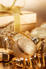 Christmas composition of Christmas tree toys on a blurred gold background