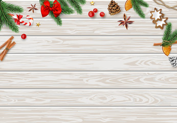 Wooden textured background with colorful Christmas decorations.