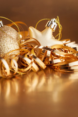 Christmas composition of Christmas tree toys on a blurred gold background