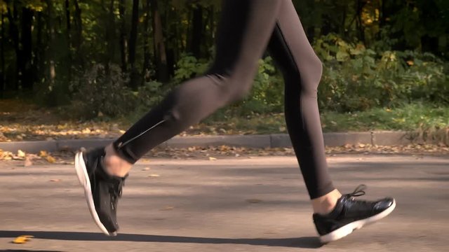 Dolly shot, cropped image of running legs in profile