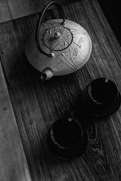 Cast iron tea set on wooden table