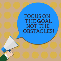 Conceptual hand writing showing Focus On The Goal Not The Obstacles. Business photo text Be determined to accomplish objectives Hu analysis Hand Holding Megaphone Color Speech Bubble
