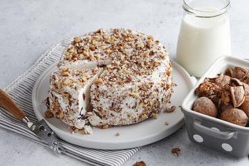 Round homemade goat cheese with walnuts and cranberries
