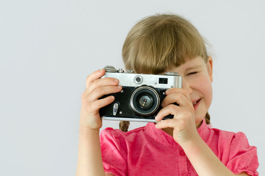 (kid, child) little girl takes pictures with an old camera