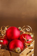 Christmas composition of Christmas tree toys on a blurred gold background