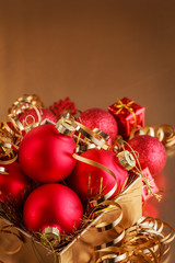 Christmas composition of Christmas tree toys on a blurred gold background