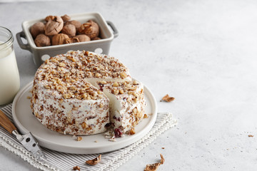 Round homemade goat cheese with walnuts and cranberries