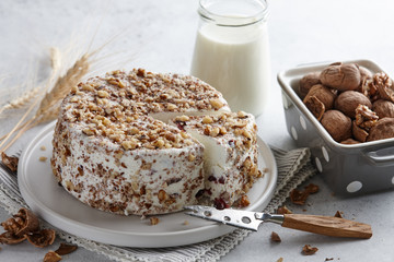Round homemade goat cheese with walnuts and cranberries