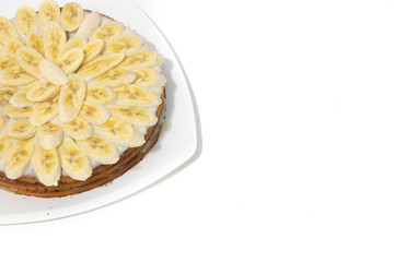 Banana cake biscuit on a white background. Sweet cake with condensed milk sauce.