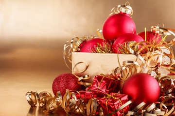 Christmas composition of Christmas tree toys on a blurred gold background