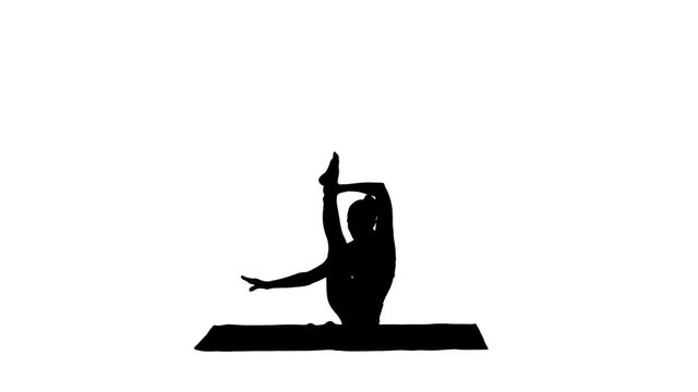 Silhouette Sporty yogi girl doing fitness practice, stretches, yoga asana Parivritta Kraunchasana.